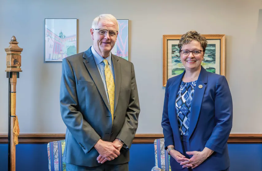 Presidents of St. Ambrose University and Mount Mercy University stand together in office.